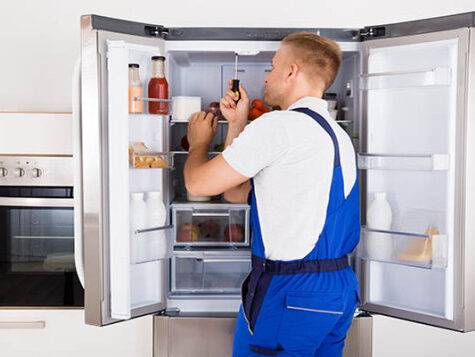 Technician Repairing Refrigerator